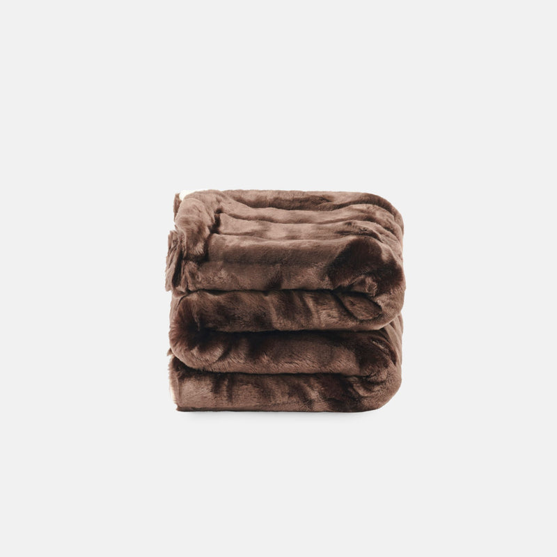 small folded minimink chocolate faux fur blanket on cream background