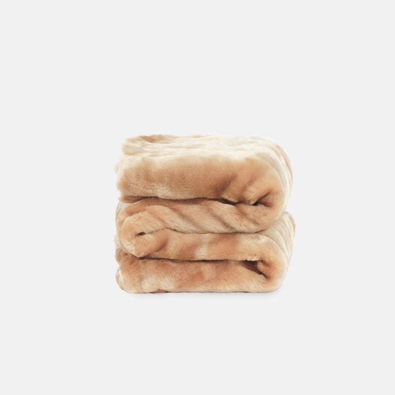 small folded minimink honey faux fur blanket on cream background
