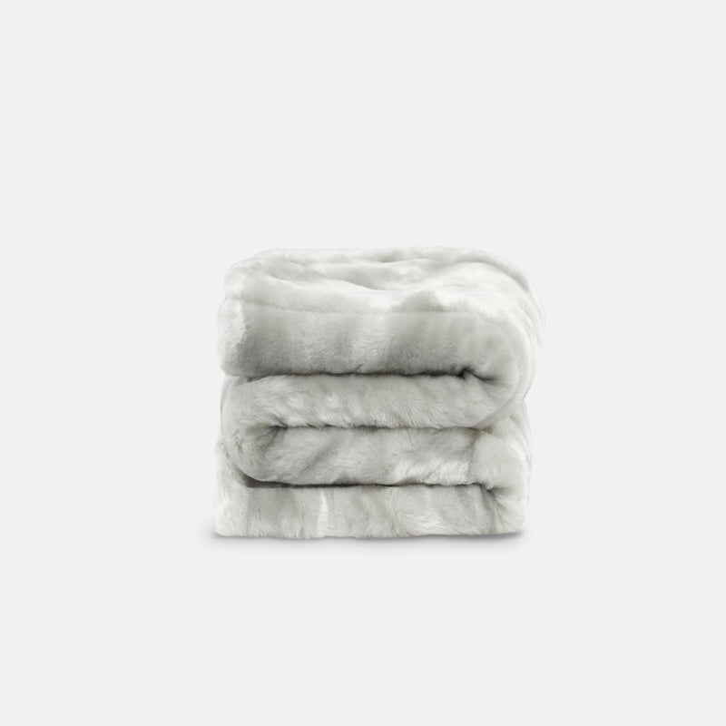 small folded minimink silver faux fur blanket on cream background
