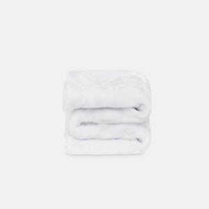 small folded minimink white faux fur blanket on cream background