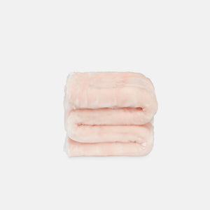 small folded minimink pink faux fur blanket on cream background
