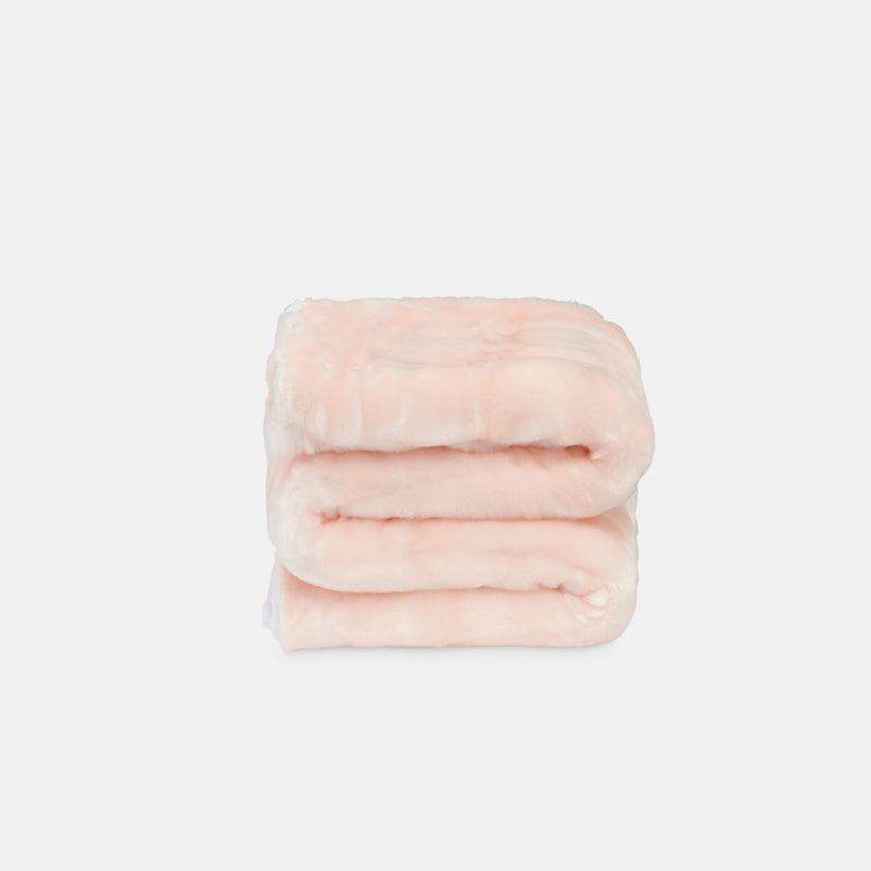 small folded minimink pink faux fur blanket on cream background