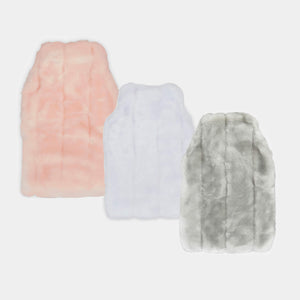 three faux fur hot water bottle covers in pink white and silver on cream background